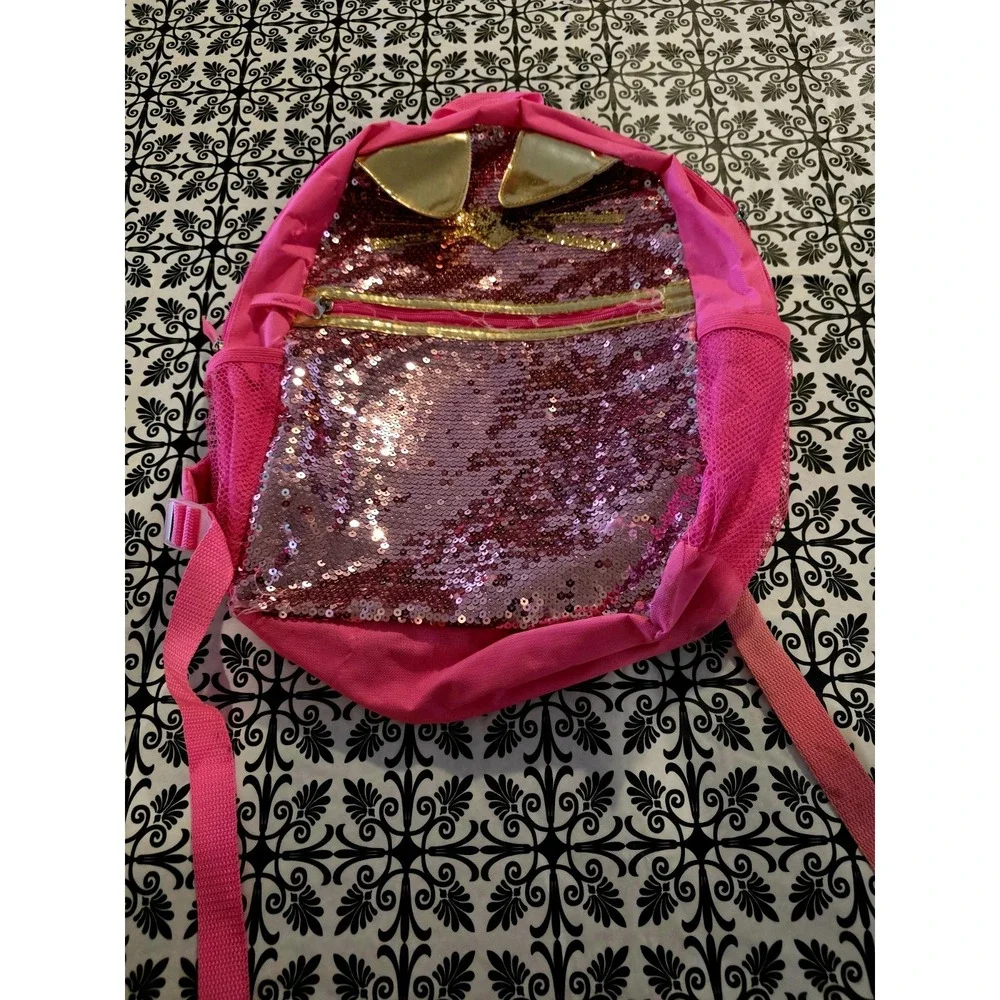 Bright pink sequin backpack. Gold Cat ears matching gold. Good. Few Minor Flaws.